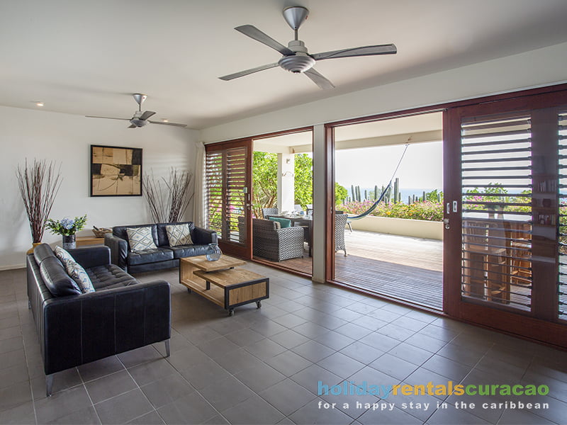 Spacious livingroom with ceiling fans and seaview