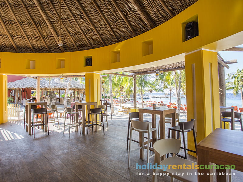 Beach bar with standing tables and a view of the sea curacao